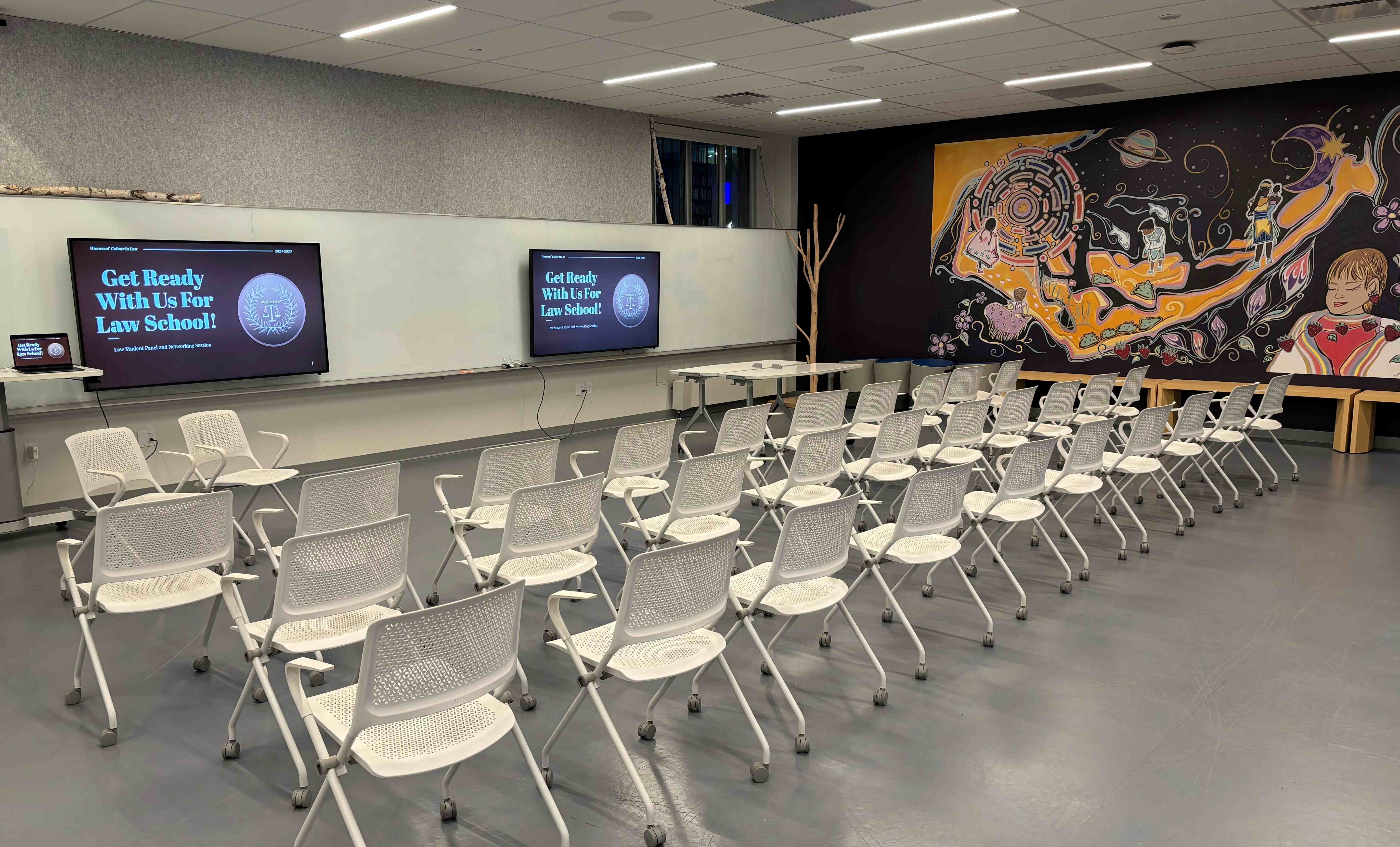 Two A/V screens with continuous dry-erase board